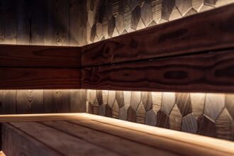briloner leuchten - A sleek Nordic-style sauna interior featuring wood paneling and modern LED light