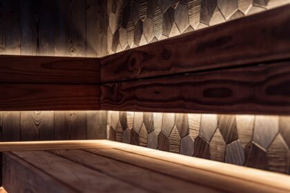 briloner leuchten - A sleek Nordic-style sauna interior featuring wood paneling and modern LED light