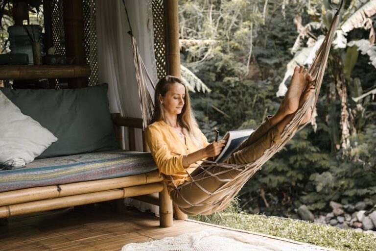 lento - Serene scene of a woman sketching in a hammock surrounded by lush greenery.